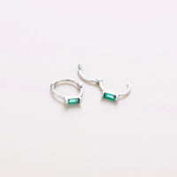 Mini silver huggies with green gem