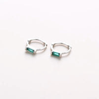 Mini silver huggies with green gem