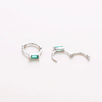 Mini silver huggies with green gem