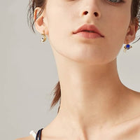 odd pair astronaut with moon earrings in gold