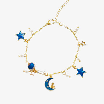 charm bracelet with moon and cat charms in gold