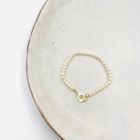 vintage bracelet with faux beige pearl in gold