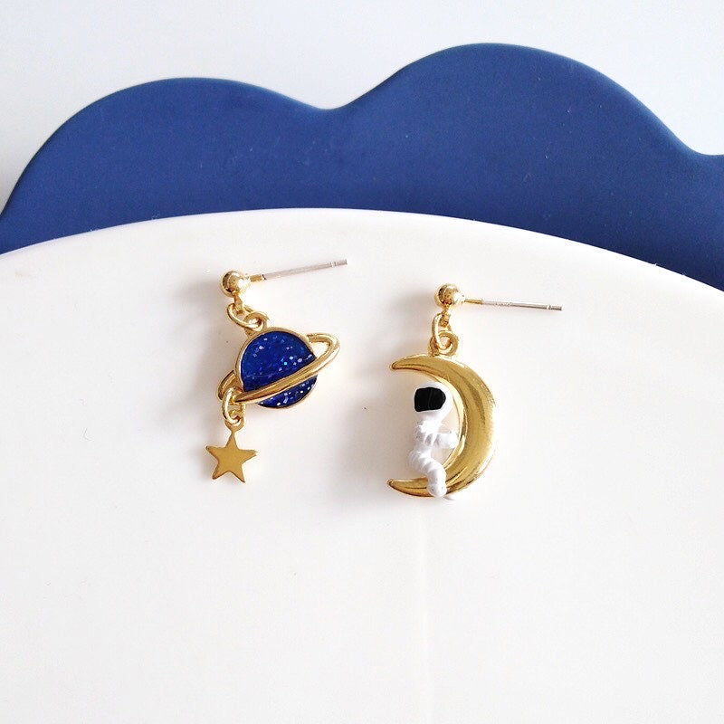 odd pair astronaut with moon earrings in gold Chili fashion art gallery