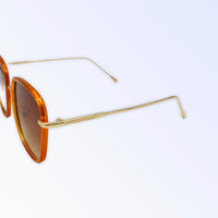 Small square sunglasses in orange with classy gold arm