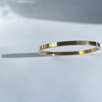 Oval shape titanium steel bangle in gold