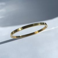 Oval shape titanium steel bangle in gold