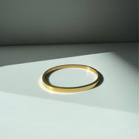 Oval shape titanium steel bangle in gold