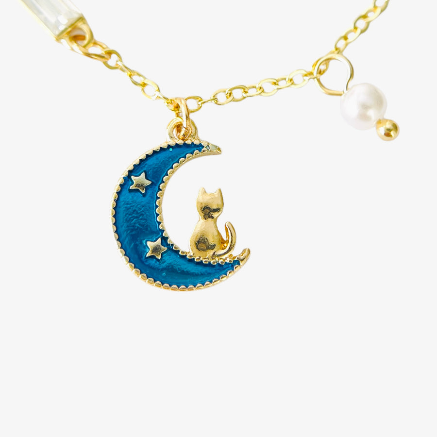 charm bracelet with moon and cat charms in gold